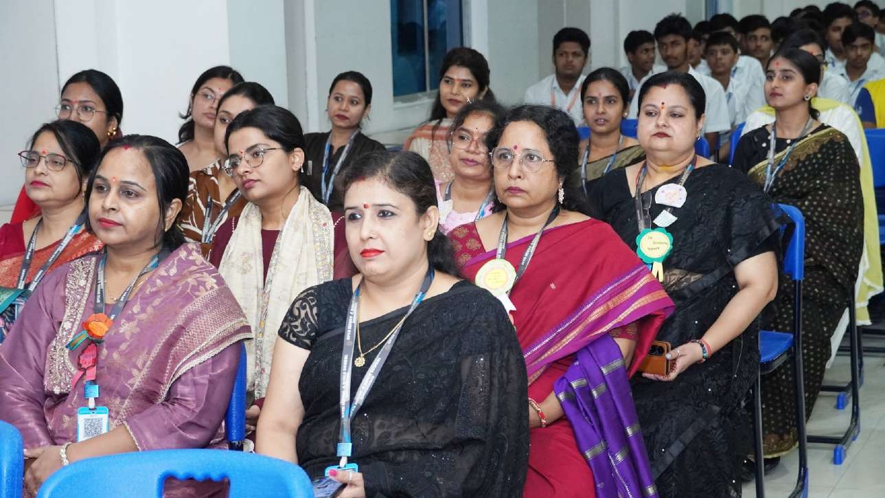 Teachers and faculty enjoying student performances in auditorium
