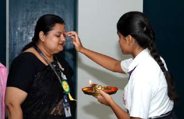 Warm Felicitations: Student Presenting Auspicious Tilak