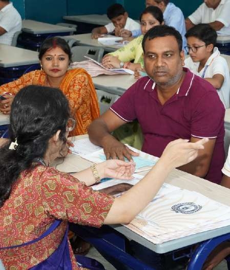 Parents actively participating in student interview dialogue