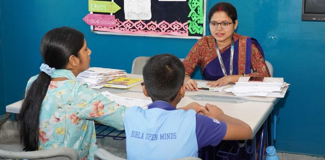 Teacher engaged in meaningful conversation with mother and student