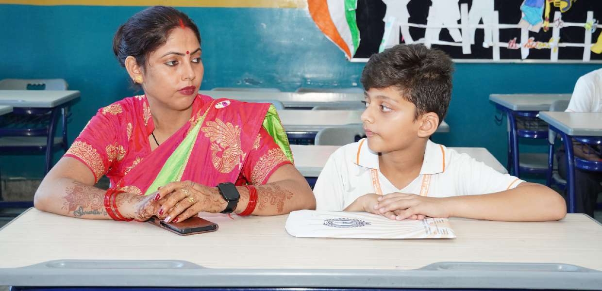 Mother in pink and green saree listening to son's reflections
