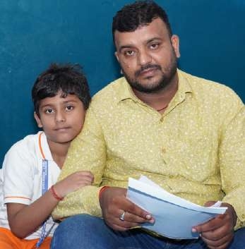 Father and son holding evaluation report together