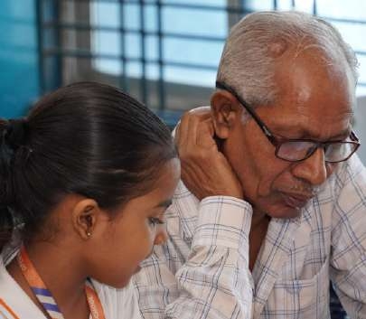 Grandfather listening intently to his granddaughter