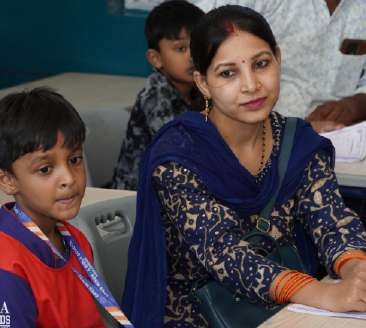 Mother in navy blue printed dupatta and young son