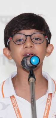 Young student with glasses reciting poem into microphone