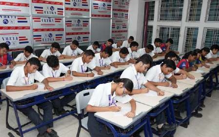 Students writing Hindi essays and short stories in classroom