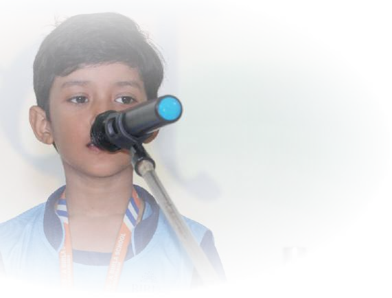 Young boy reciting into microphone