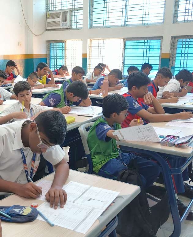 Focused student writing SOF exam in examination hall