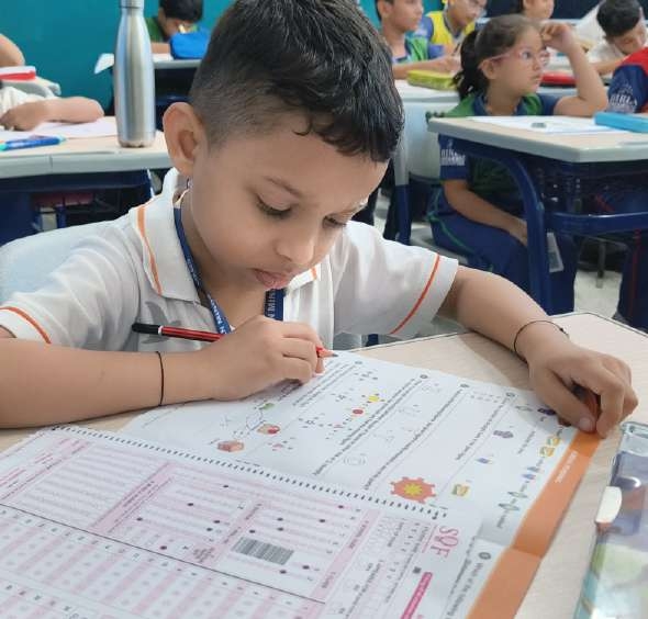 Student carefully bubbling answers on the OMR sheet