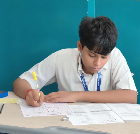 Student working methodically with yellow pen