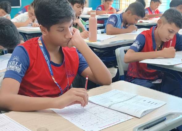 Student in Birla uniform in deep analytical contemplation