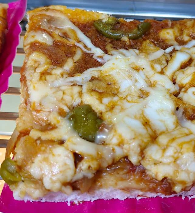 Baked cheesy puff pizza slice