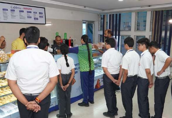 Students lining up in queue at the canteen counter